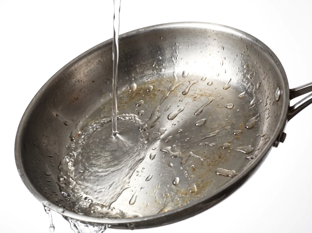 Grease doesn't come off a pan with water alone.